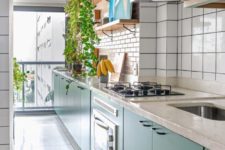 02 The kitchen is long and narrow, done with green cabinets, white terrazzo countertops, blush and white tile backsplashes