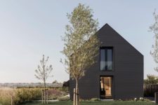 02 The traditional barn shape of the house is complemented with lots of glazing and bold black exterior