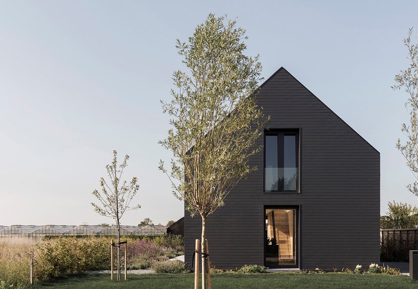 The traditional barn shape of the house is complemented with lots of glazing and bold black exterior