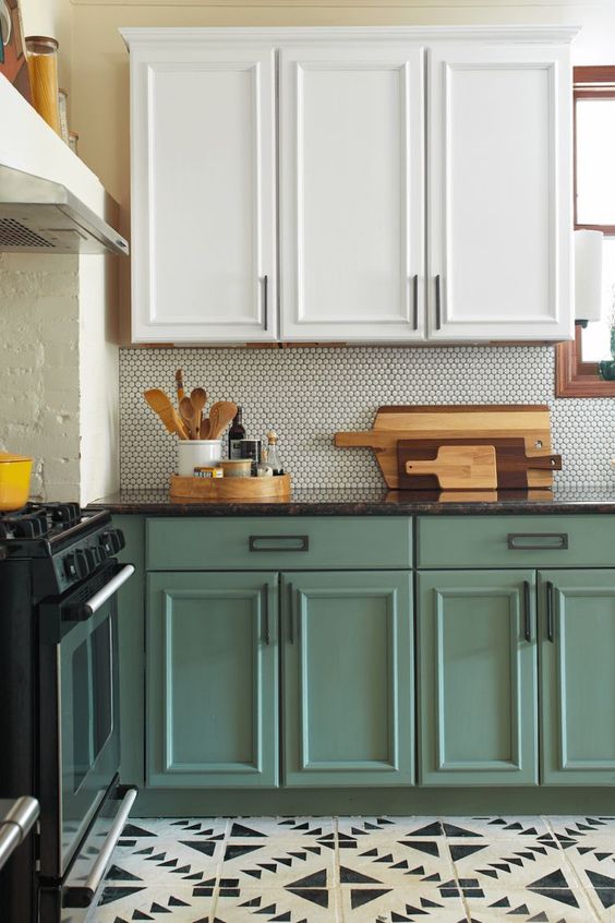 A trendy two tone kitchen with upper white cabinets and lower chalk painted ones looks very chic
