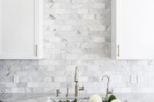 02 two-toned gray and white cabinets, marble subway tile, Carrara countertops, a big farmhouse sink, and brass hardware for a farmhouse kitchen