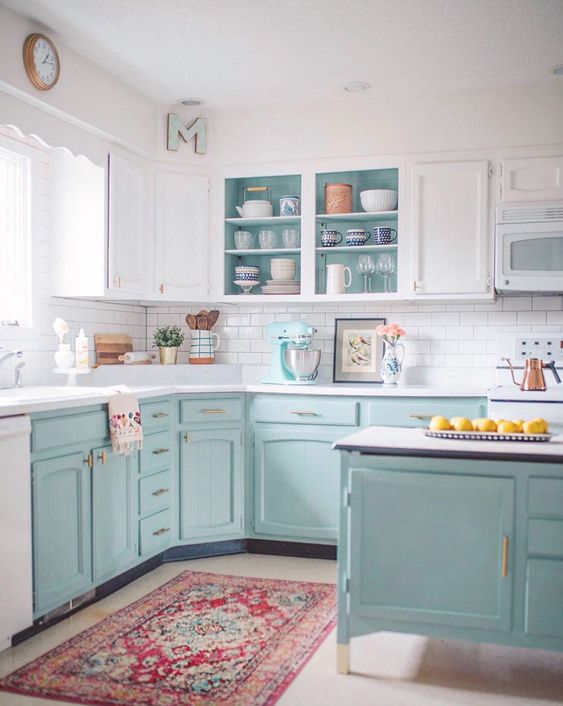 a two-tone kitchen with white uppers and light blue lowers plus gold hardware looks cool