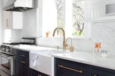 04 a black kitchen with white stone countertops and a backsplash looks very contrasting