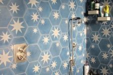 05 a chic bathroom clad with navy and brass star tiles looks very bold and very dreamy with these celestial tiles