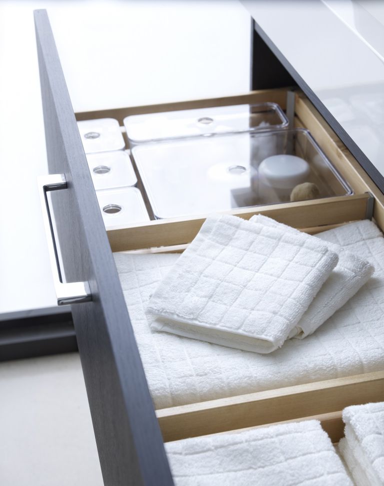 a drawer in the vanity will save much space and hold everything you need, from towels to makeup
