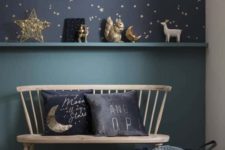 06 a romantic nook with navy and gold star wallpaper, some stars and moon figurines and matching pillows