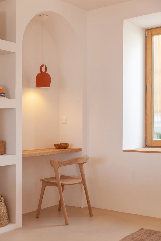 A small home office nook shows off a tiny desk and a wooden desk