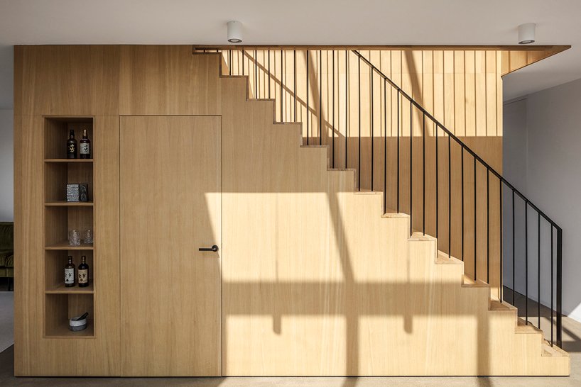 The staircase is a cool pantry and open storage unit, it's very functional, which is a great solution to steal