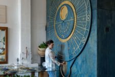 07 a gorgeous oversized moon calendar themed wall art in blue and gold is a bold statement
