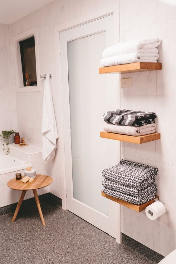 floating shelves for towels don't look bulky and don't clutter your bathroom, this is a cool solution