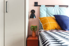 09 The bedroom also shows off bright colors and prints and matte black touches add drama here