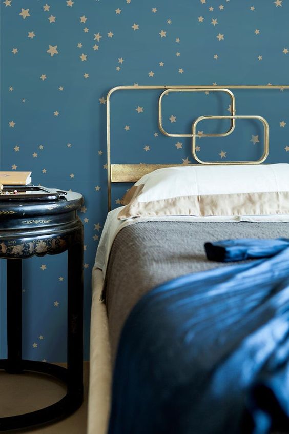 navy and gold star wallpaper and a gold bed with gold and navy bedding will make up a beautiful celestial bedroom