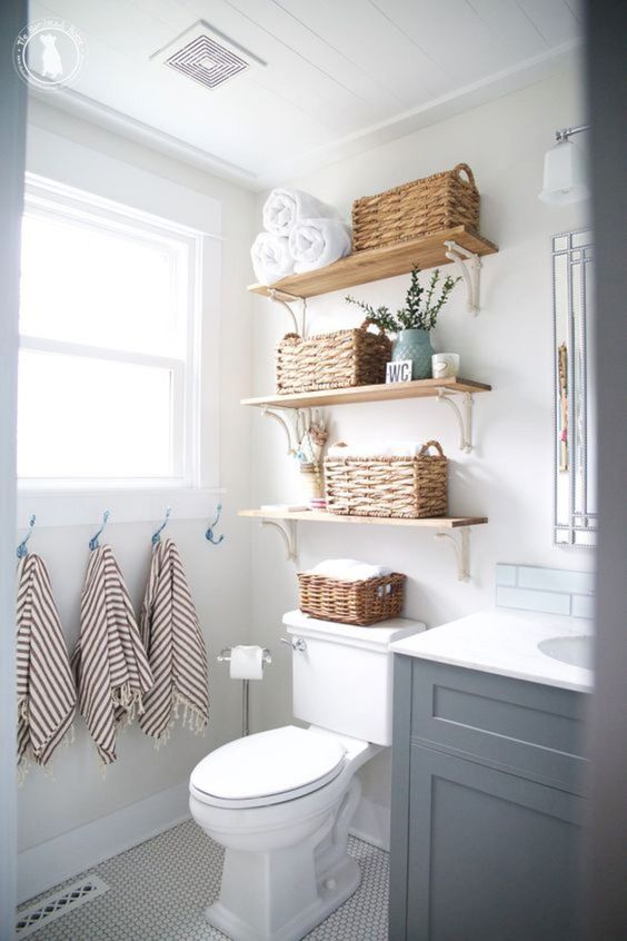 open shelves with baskets can store towels comfortably and here they take just some awkward space over the toilet