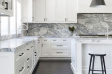 11 a neutral farmhouse kitchen with a white marble backsplash and countertops and black touches and a black floor