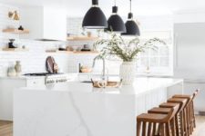12 a white kitchen with sleek cabinets, floating shelves, a white marble kitchen island and black pendant lamps