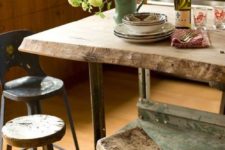 13 a rough wooden table and kitchen island, with mix and match wooden stools looks very rustic