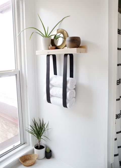 a wood and leather strap towel shelf will let you store not only towels but also decor and accessories