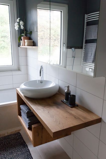 a modern wooden vanity with an open storage space that allows to store some towels is a cool idea