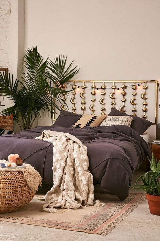 a boho bedroom with phases of the moon headboard in gold is a perfect choice for a celestial space