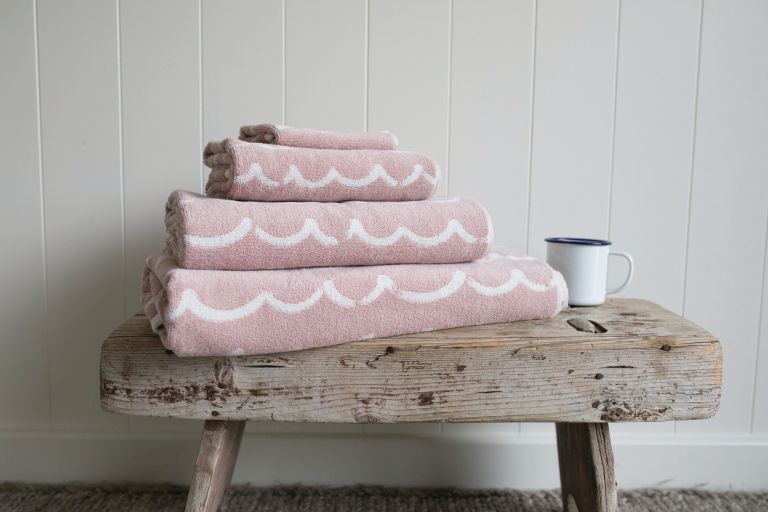 a rustic side table or bench will always add a natural touch to the space and you can store towels on it