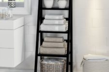 16 a black ladder is a space-saving storage unit for any bathroom, it works not only for towels but also for other pieces