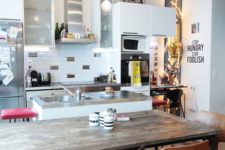 16 a quirky kitchen with a wooden table and al mismatching chairs and stools at the tables