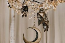 18 a chandelier with coins, 3D star candleholders and a moon will make your space very boho and celestial