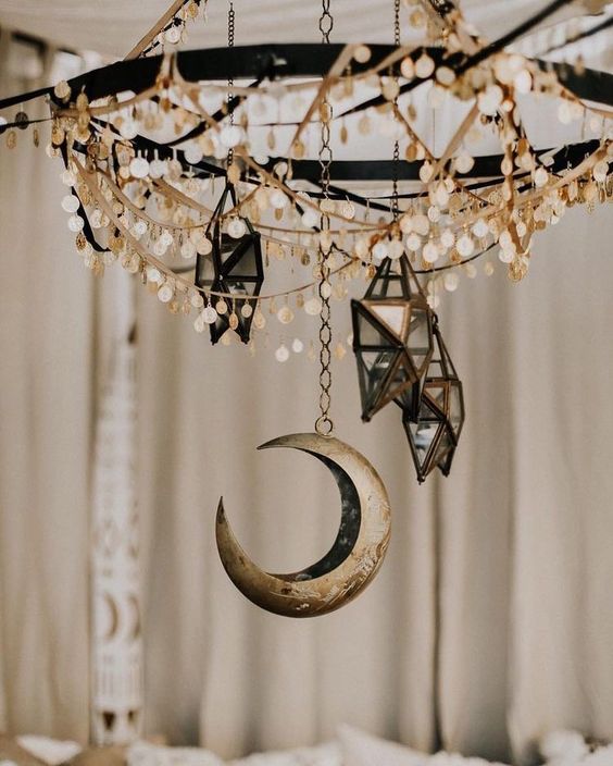 a chandelier with coins, 3D star candleholders and a moon will make your space very boho and celestial