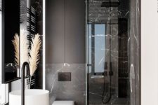 18 a refined minimalist bathroom with black marble tiles, black matte surfaces and white appliances for a bold look