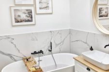 18 a small contemporary bathroom with a white marble backsplash and white furniture plus a gallery wall