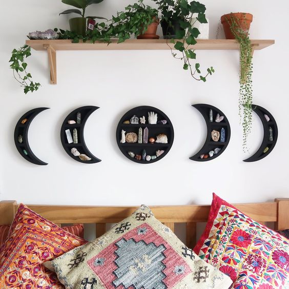 A cool phases of moon wall shelf in black with geodes is a very lovely home decor idea