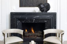 20 a catchy fireplace nook with a black marble clad fireplace, refined chairs and a black marble side table