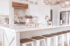 20 a white farmhouse kitchen with vintage gold faceted pendant lamps over the kitchen island