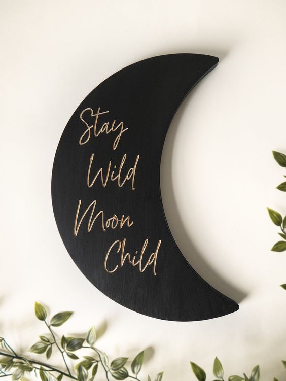 a stylish black matte moon sign with gold calligraphy is a lovely modern celestial decoration that can be attached anywhere