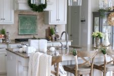 22 a cozy farmhouse kitchen with a row of glass and wood pendant lamps over the kitchen island