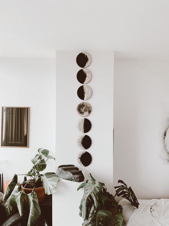 A wall art with moon phases is very lovely and looks modern and bold, perfect for a boho space
