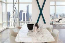 23 a contemporary luxurious dining table with a black base and a white marble tabletop for ultimate chic