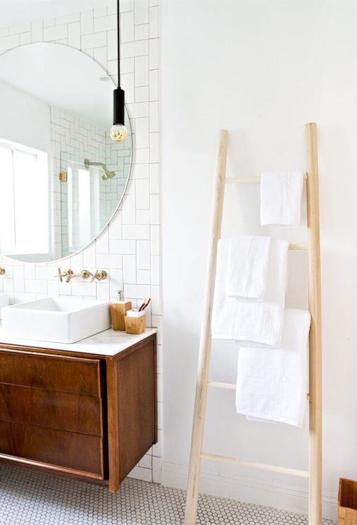 a simple wooden ladder with some towels is a cool space-saving towel storage idea for every kind of bathroom