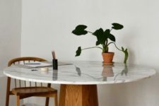 25 an elegant mid-century dining table with a wooden faceted base and a white marble tabletop