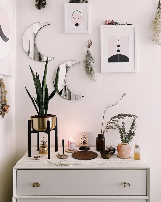 mini moon mirrors and abstract artworks plus herbs look cool and bring a romantic celestial feel to the space