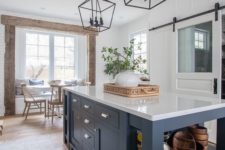 26 a navy kitchen island that includes an open storage space and some drawers, too