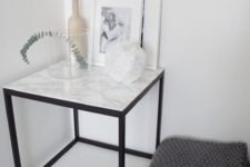 26 a side table with a black metal base and a white marble countertop – if you can’t afford marble, go for contact paper