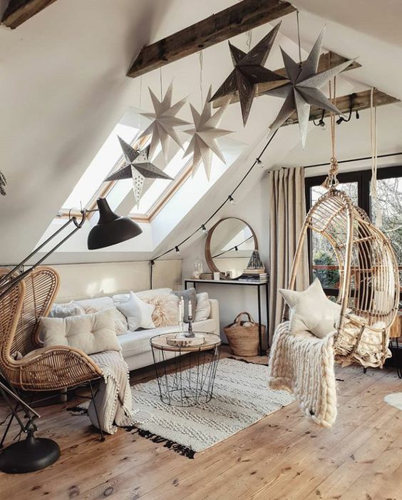 Oversized hanging stars attached to the wooden beam and some star pillows bring a celestial feel to the space