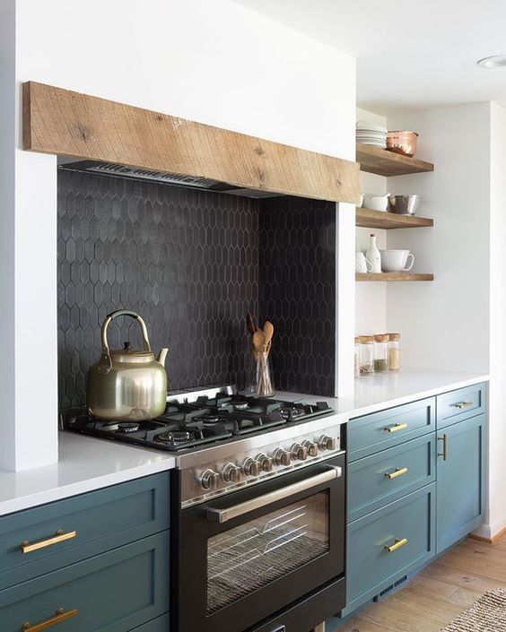 a black skinny tile backsplash and a black cooker add depth to the white and hunter green kitchen