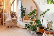 a cool boho living room design with a large round mirror