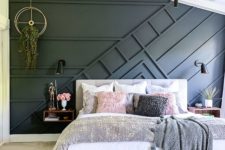 a cozy modern bedroom done in neutrals and with an accent black paneled wall that brings a bit of drama