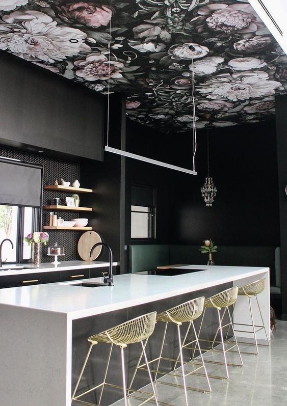 a dark dramatic kitchen with a moody floral wallpaper ceiling that adds charm and makes the space look softer