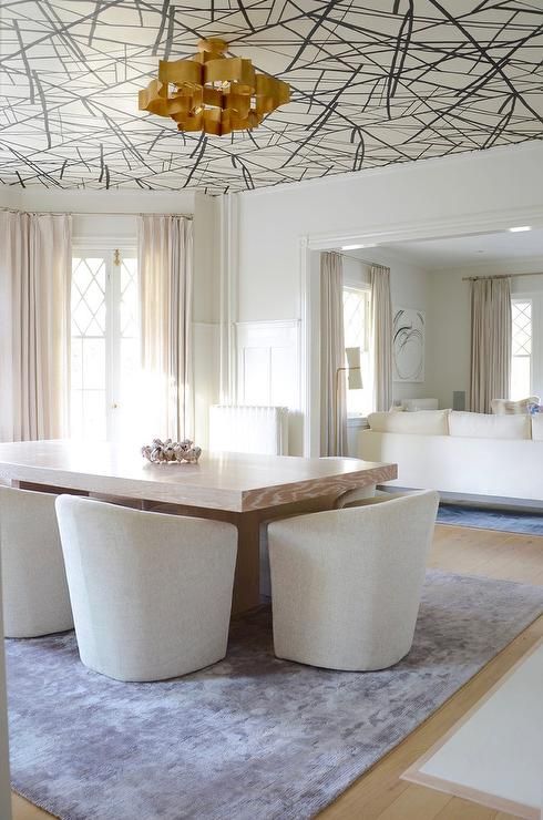 a refined dining space made bolder and edgier with graphic wallpaper on the ceiling