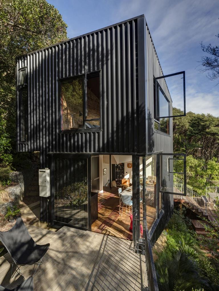 This contemporary house is built in New Zealand and features a tower like design that arises among the trees