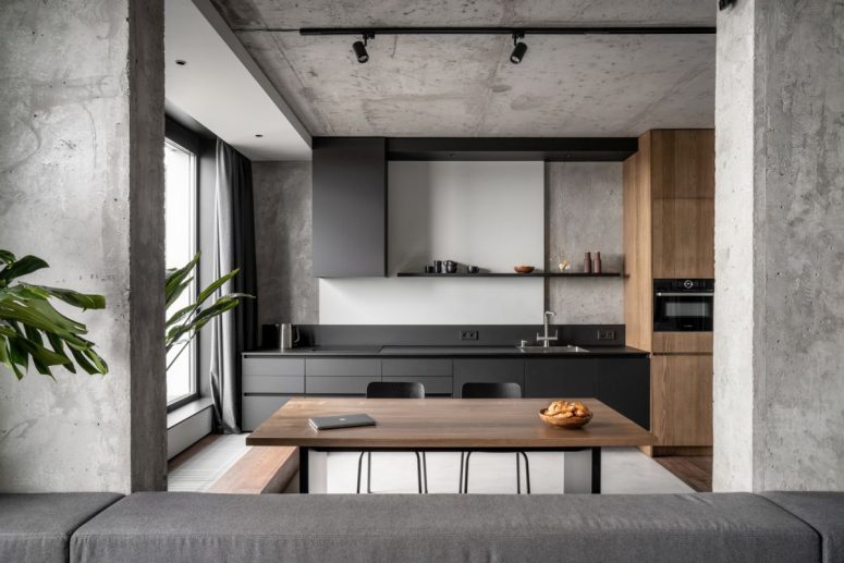 This modern apartment in a monochromatic color palette features a lot of concrete and looks absolutely timeless